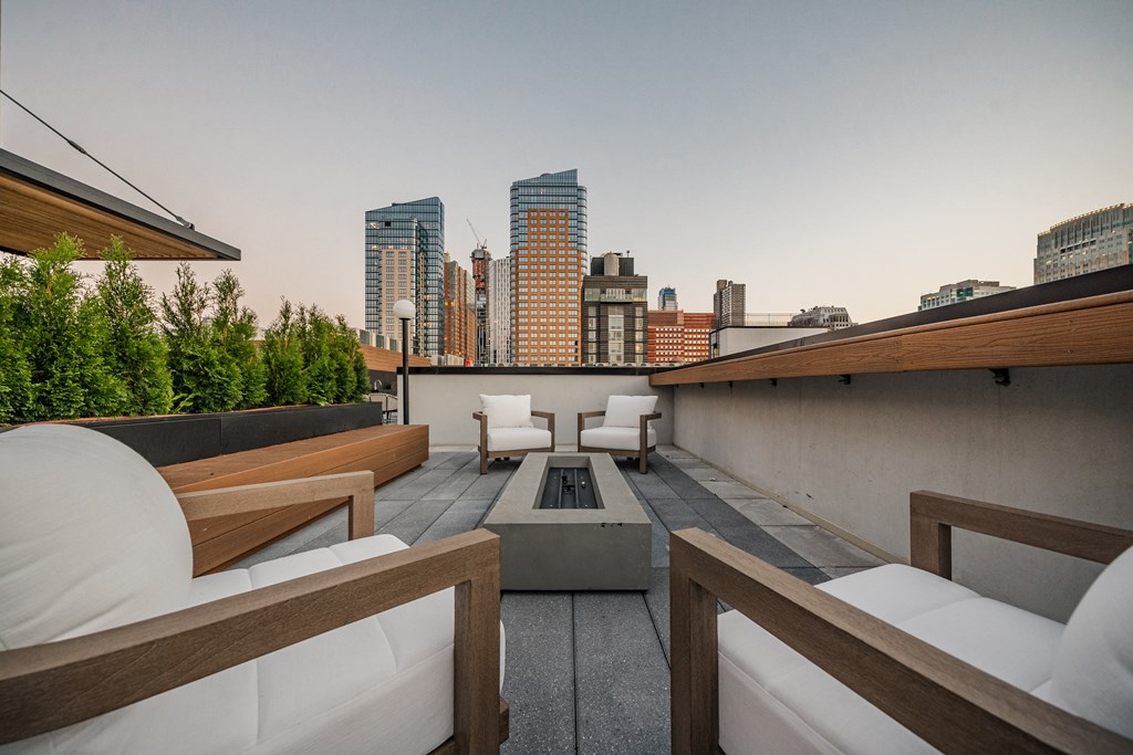 a rooftop patio with a city skyline in the background